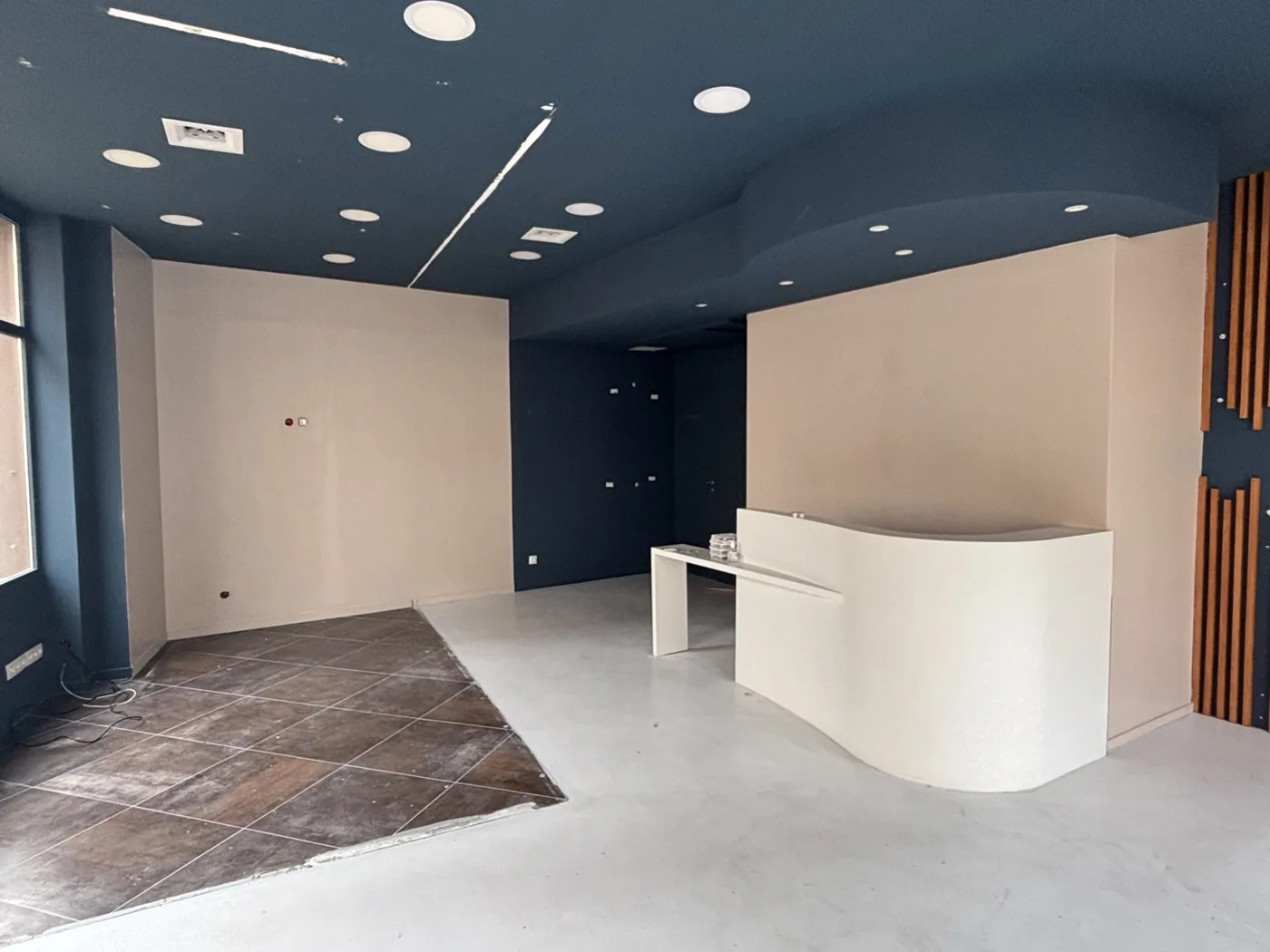 Rénovation d’un local commercial : murs beige clair et plafond bleu